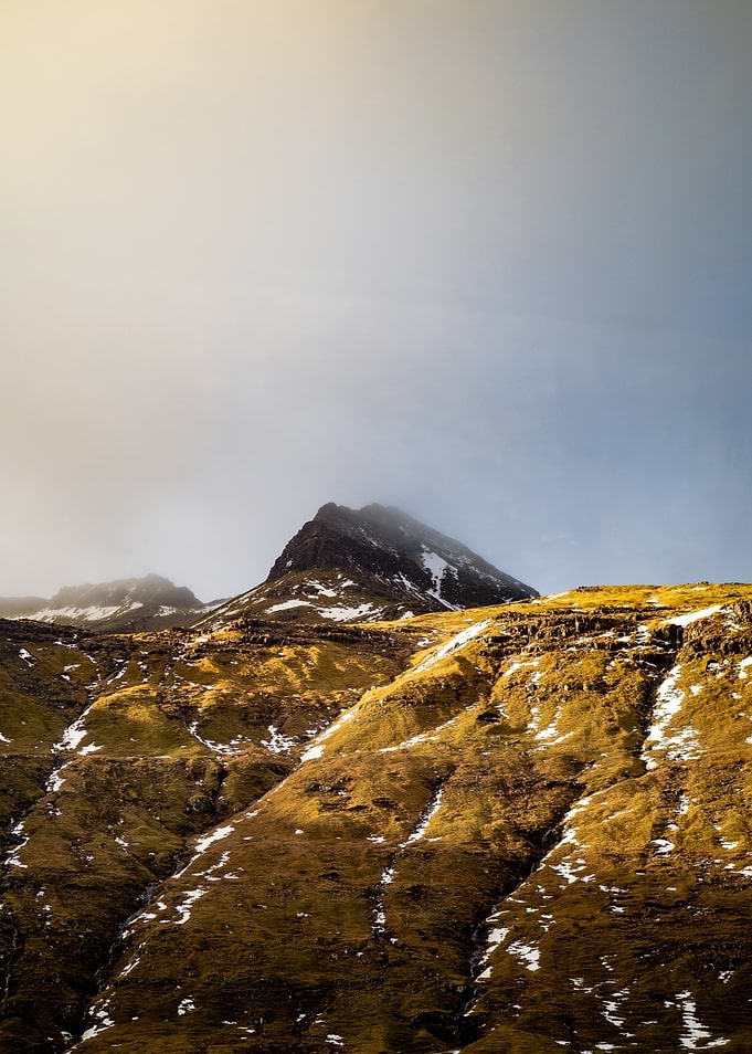 Misty Mountain Peak with Golden Slopes