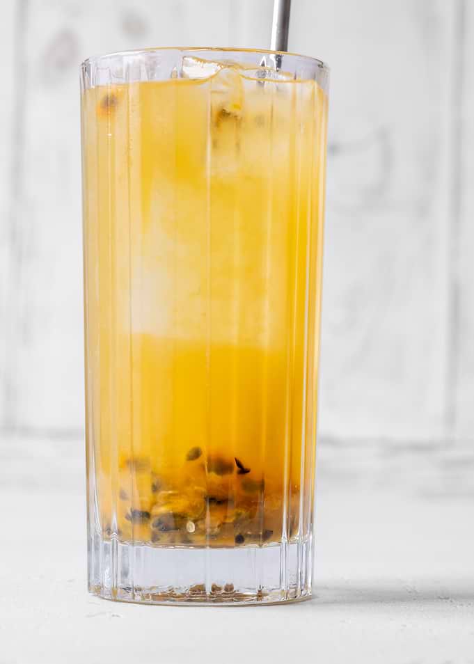 Passion Fruit Caipirinha cocktail in highball glass