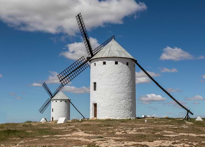 Traditional Windmills of La Mancha Under Blue Sky