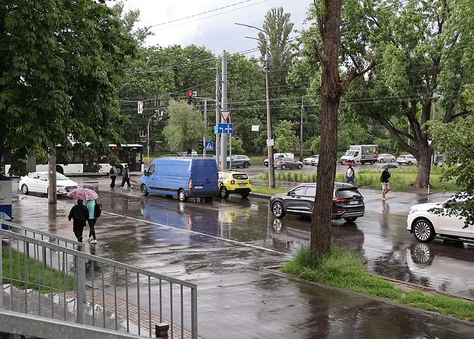 Rainy City Street with Cars and Pedestrians