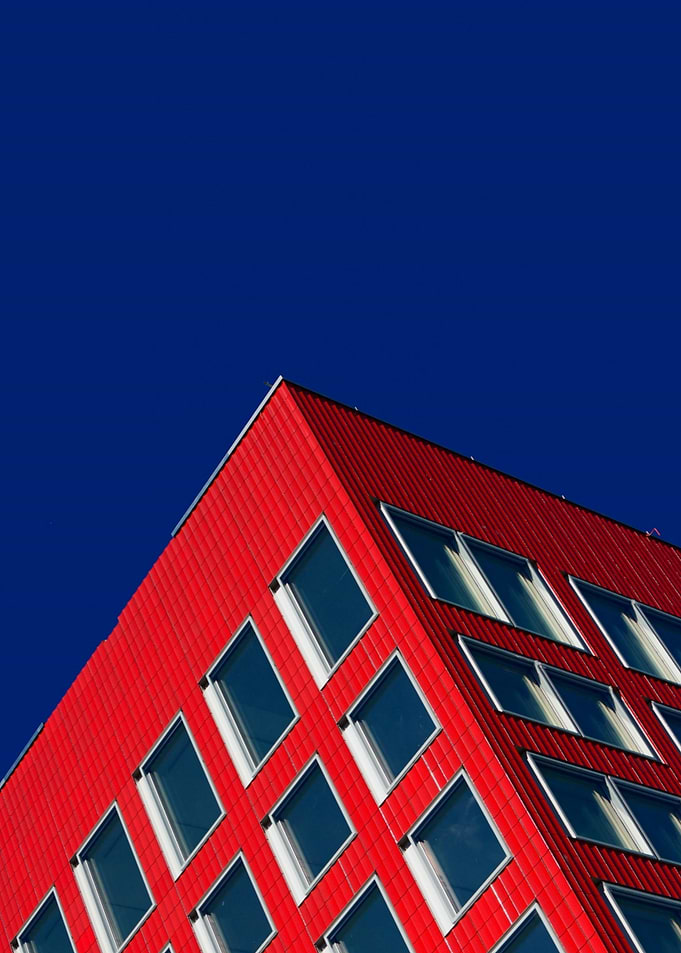 Modern Red Building Against Blue Sky