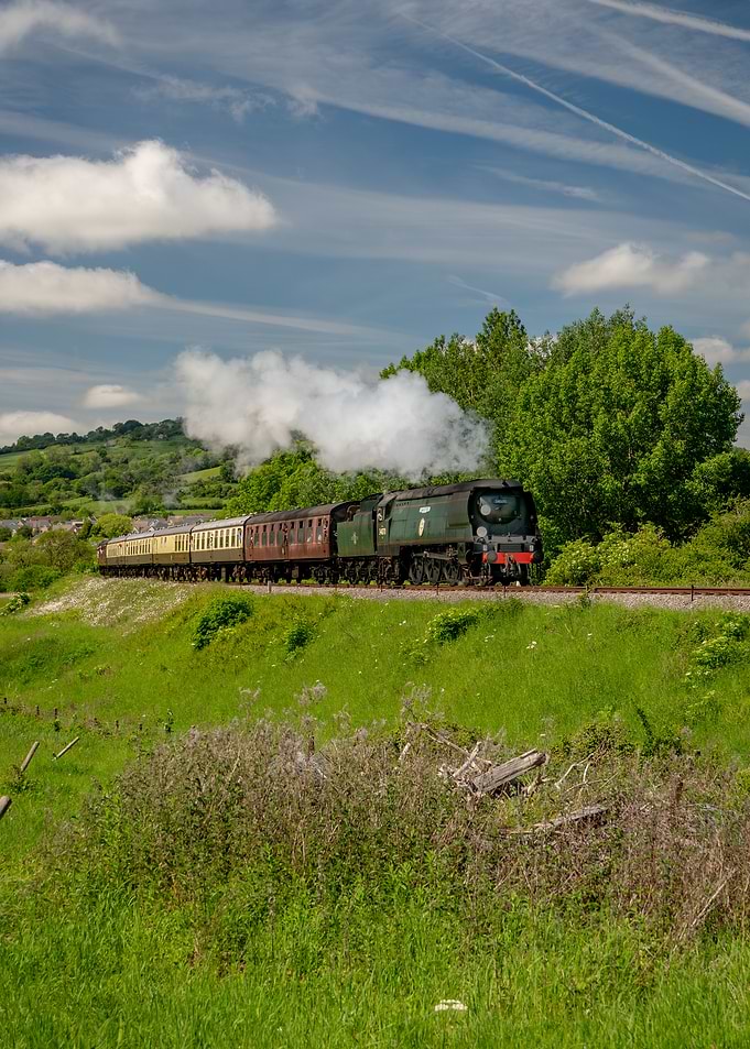 Steam Train Traveling Through Green Countryside