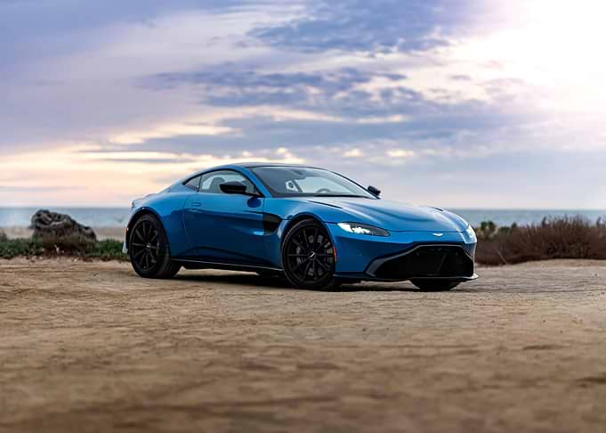 Blue Aston Martin Vantage by the Sea