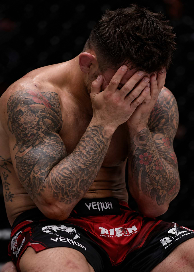 MMA fighter with hands over face