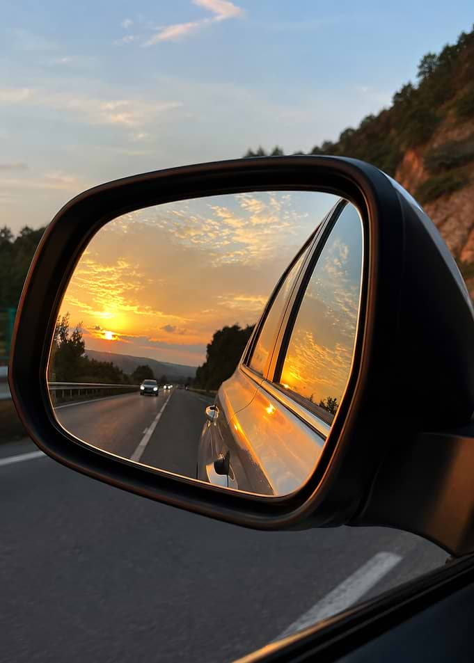 Sunset reflected in car mirror