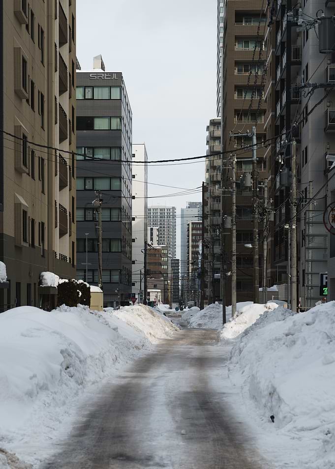 Snowy Sapporo City Street with Tall Buildings