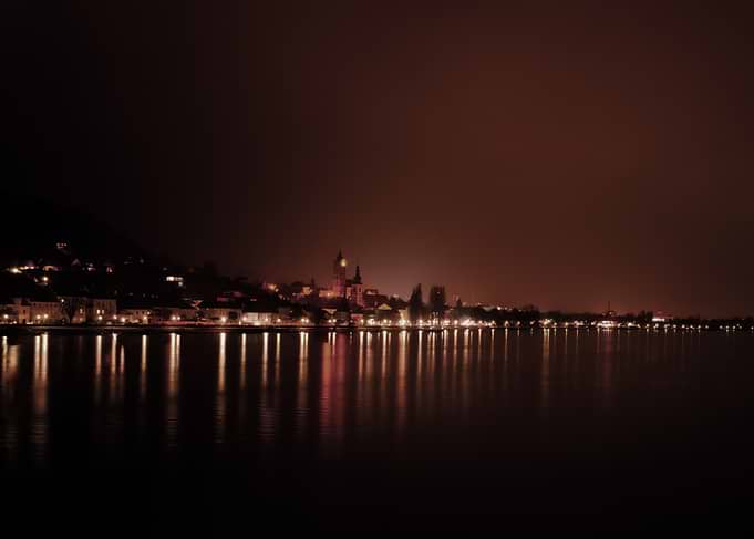 Night cityscape reflected in water