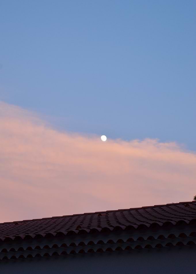 Moon in a Pink and Blue Sky Over Rooftop