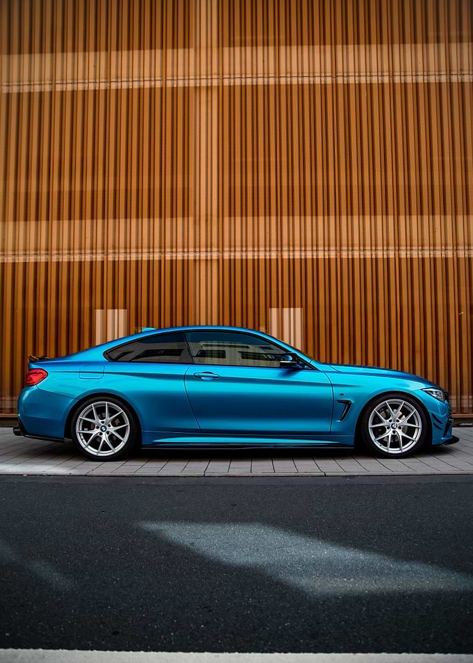 Blue BMW Coupe on a City Street