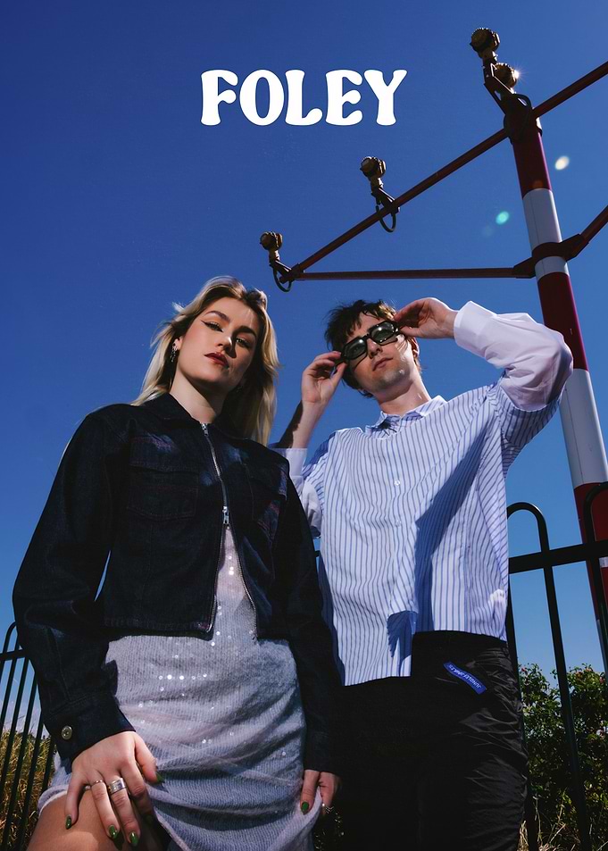Foley Duo Posing Under Blue Sky