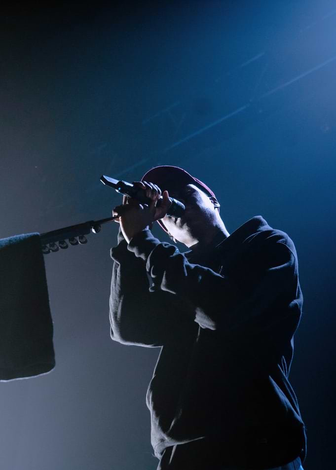 Daniel Caesar performing on stage
