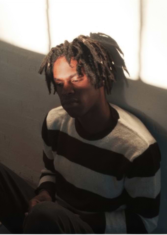 Daniel Caesar with Dreadlocks in Striped Sweater