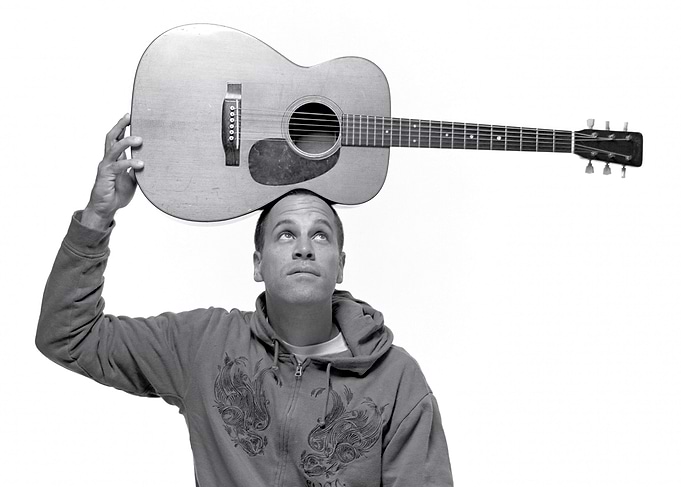 Jack Johnson Balancing Guitar on Head