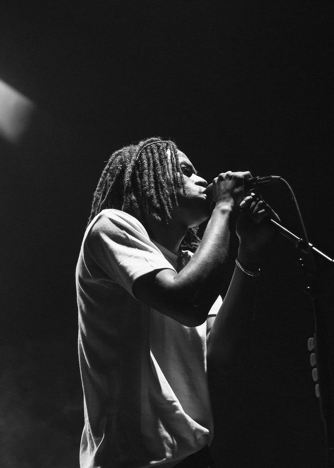 Daniel Caesar performing on stage