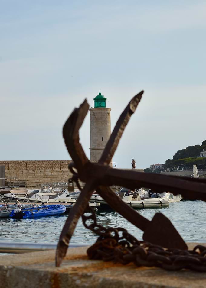 Anchor and Lighthouse in Harbor