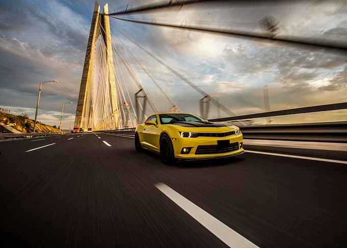 Yellow sports car on a bridge