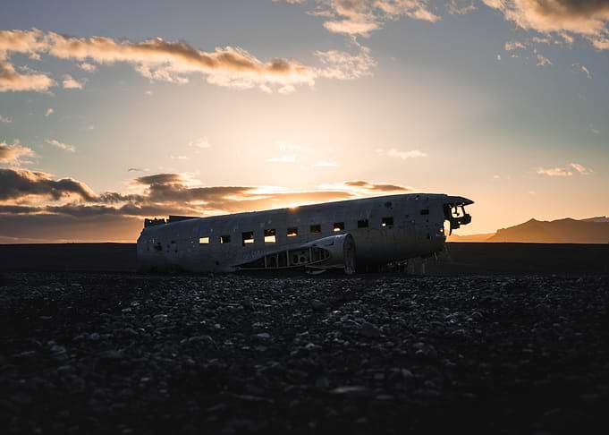 Plane Wreck on Black Sand at sunset