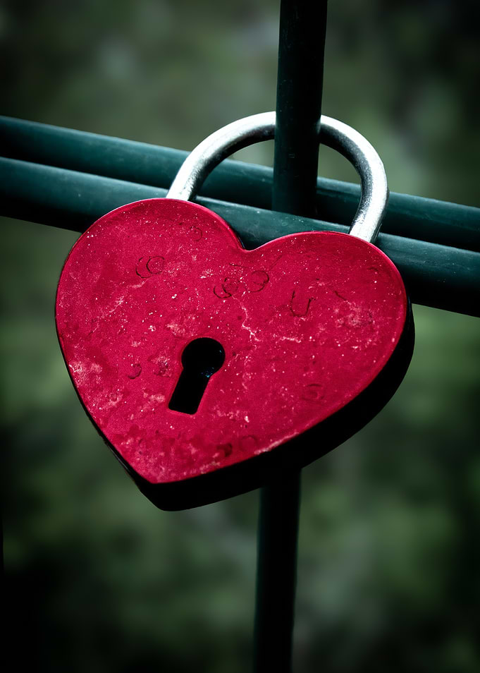 Heart-shaped padlock on a fence