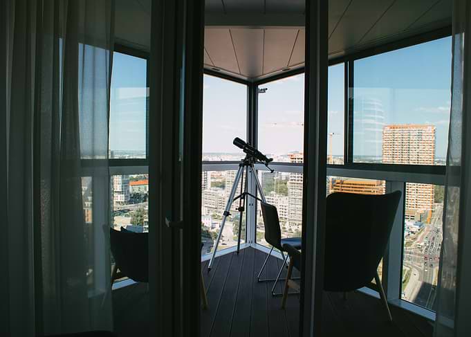 Balcony with Telescope and City View