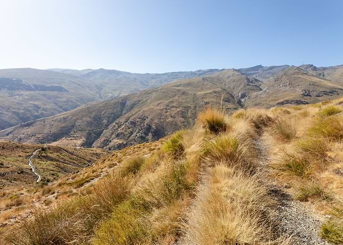 Mountain landscape with dry grass and path