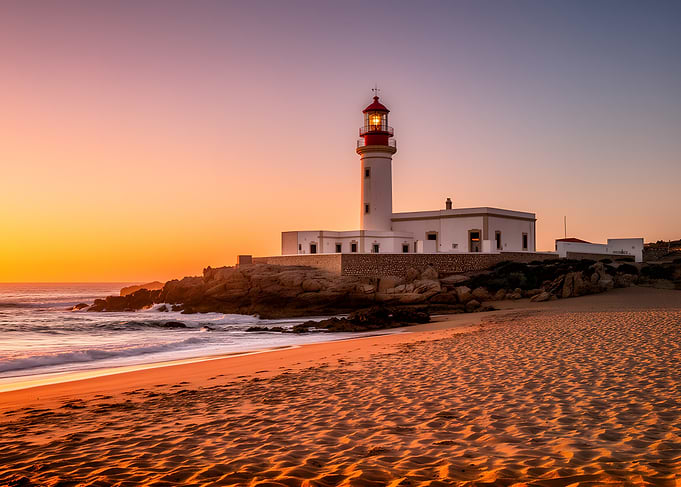 Lighthouse at Sunset on a Beach