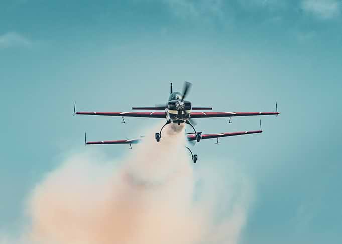 Aerobatic Biplanes Performing a Smoke Show