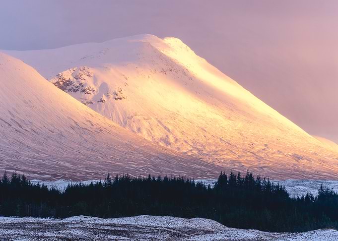 Snow capped mountains at sunset at Glencoe