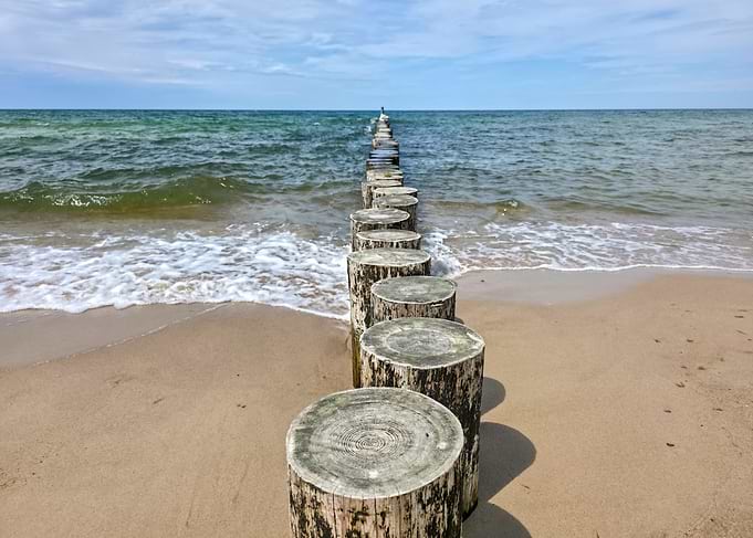 Wooden breakwaters on a sandy beach