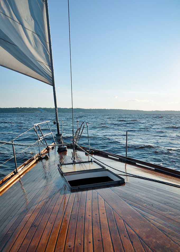 Sailing on a calm sea - yacht bow at sunset.
