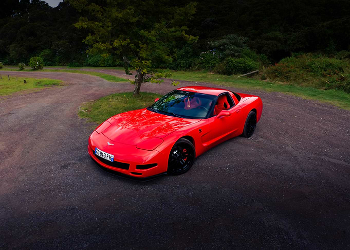 Red Corvette on a Gravel Road