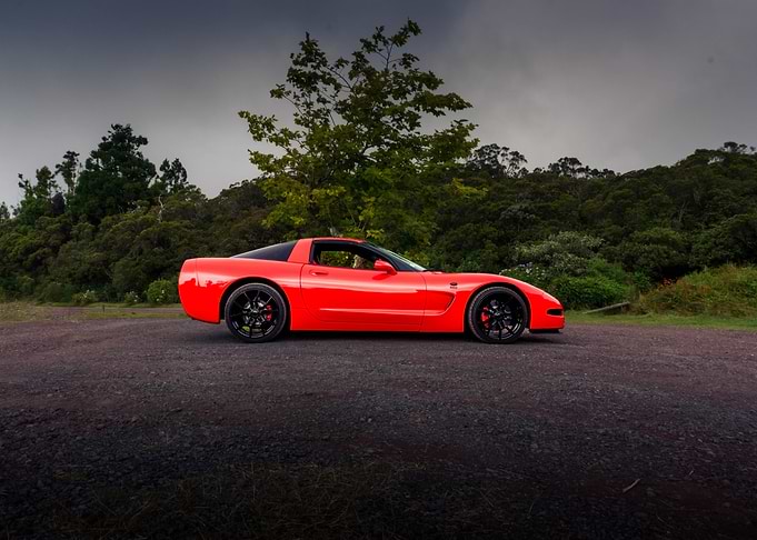Red Corvette on a Gravel Road