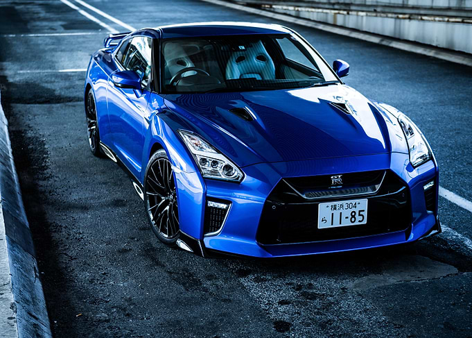 Blue Nissan GT-R Nismo on Asphalt Road