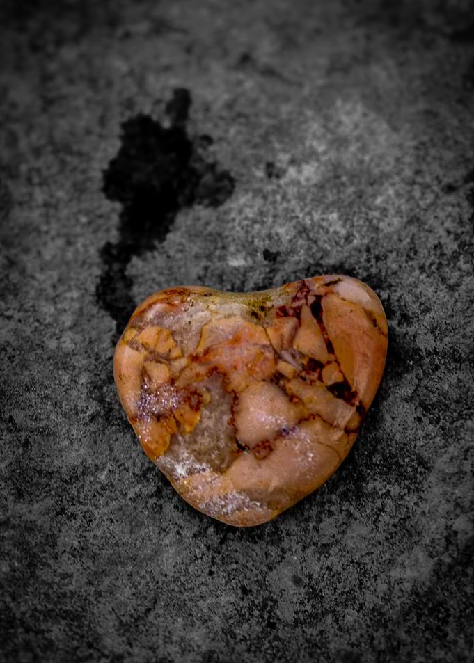 Heart-shaped stone on textured surface