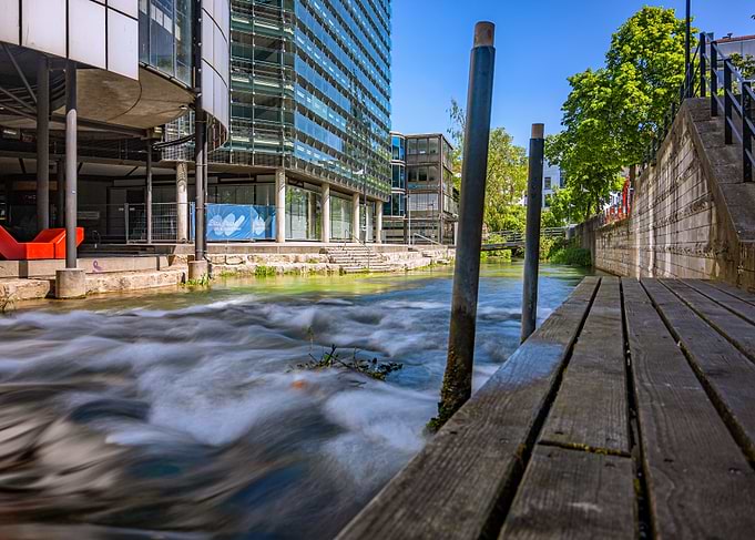 Modern Building by Flowing River