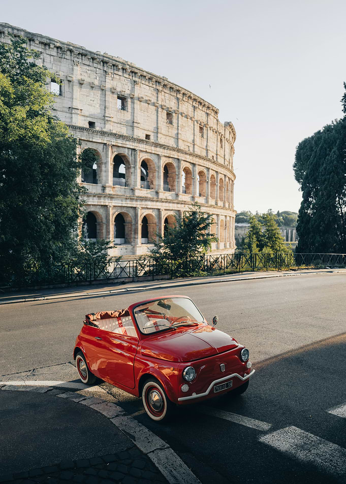 Red Fiat 500 in front of the Colosseum