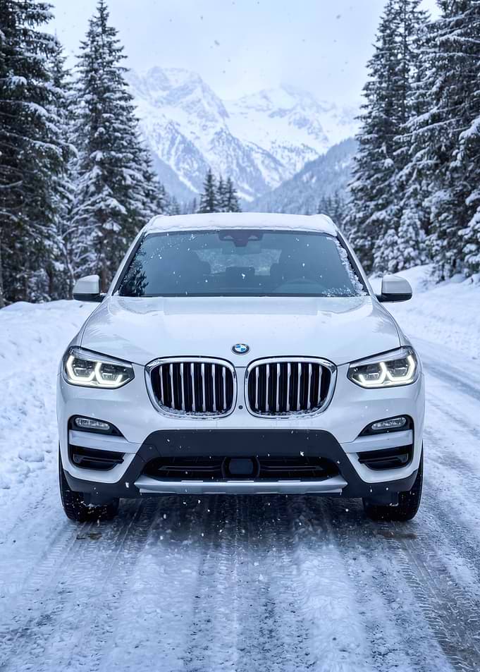 White BMW X3 in Snowy Mountains