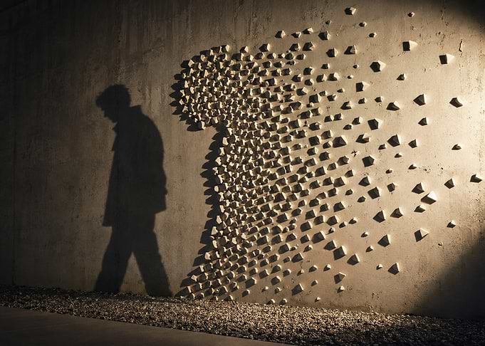 Man dissolving into wall art