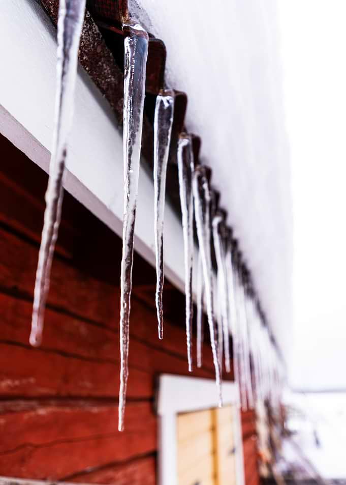 Icicles hanging from a red building