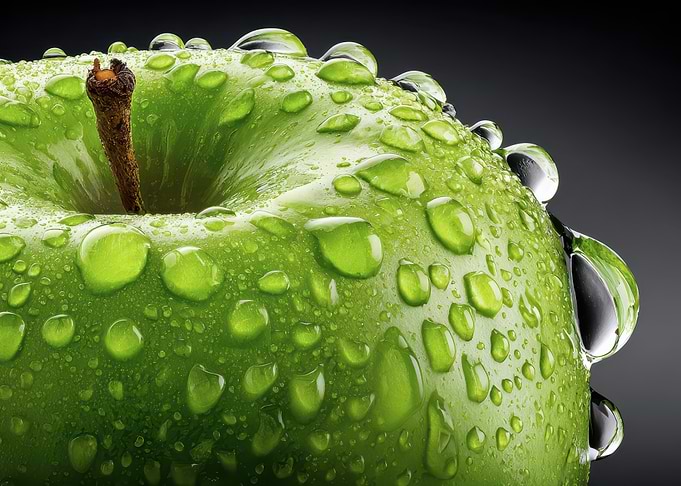 Green apple with water droplets