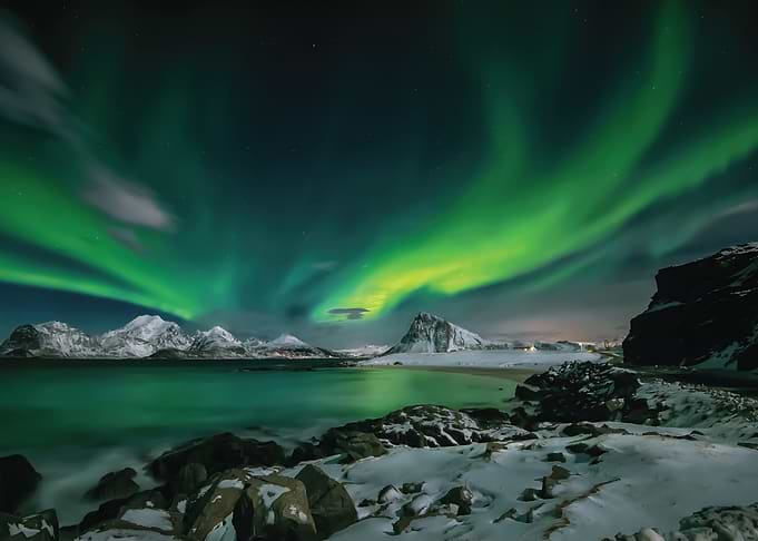Aurora Borealis over Snowy Mountains