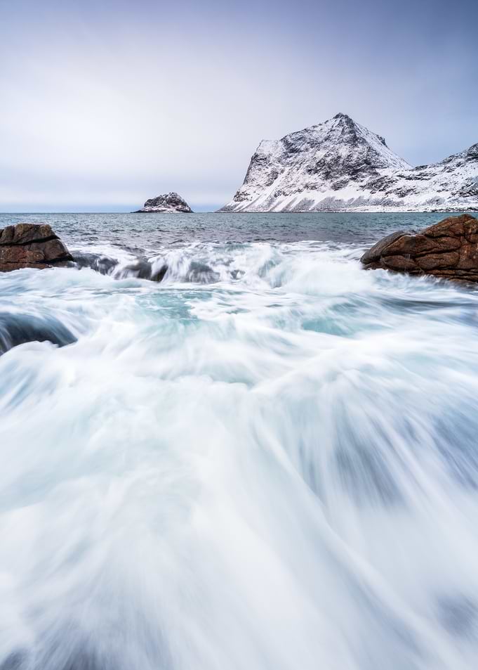 Winter Coastal Landscape with Snow-Capped Mountains