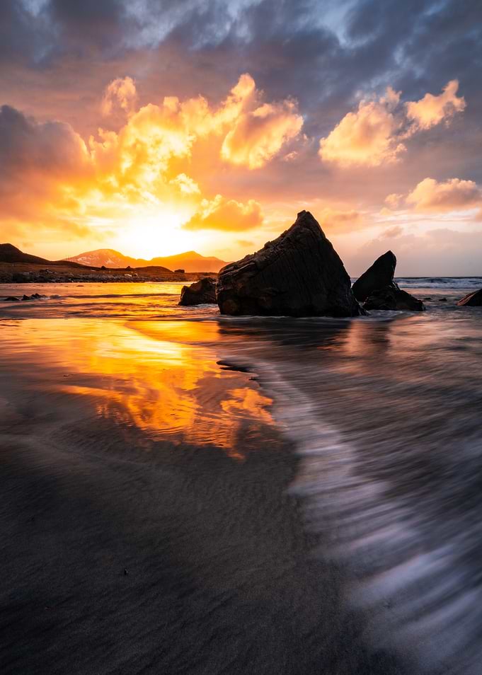 Dramatic Sunset Over Rocky Beach