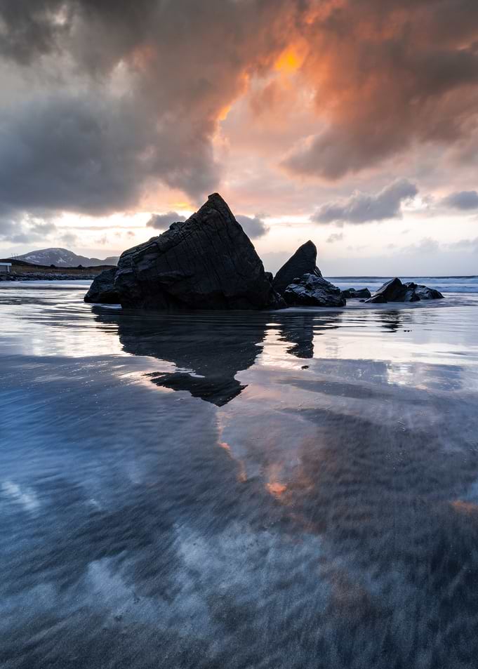 Dramatic Sunset Over Rocky Beach