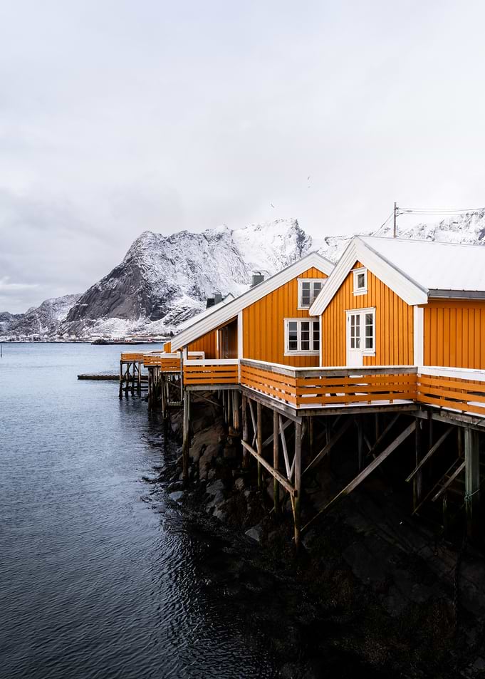 Orange Rorbuer in Snowy Lofoten