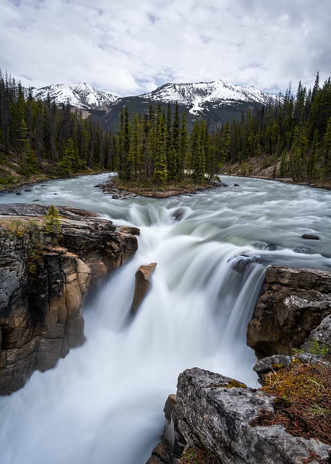 Majestic Waterfall in a Mountainous Forest