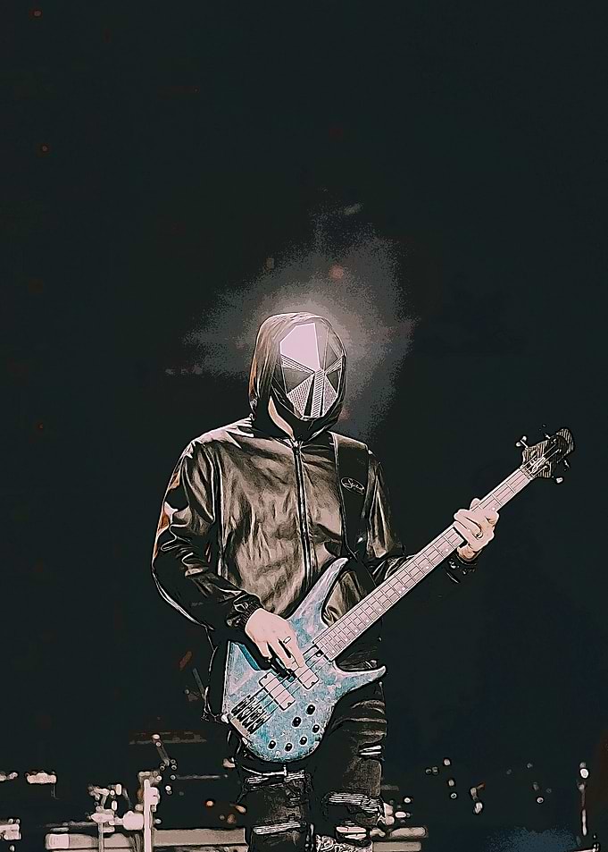 Masked Bassist Playing Guitar on Stage