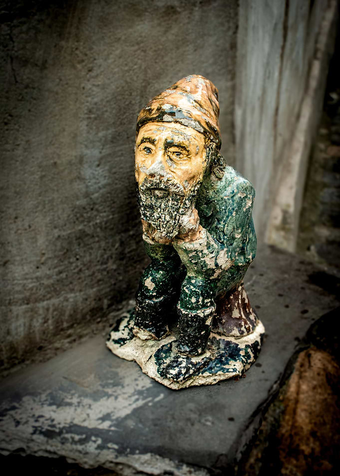 Old Gnome Figurine Sitting Thoughtfully