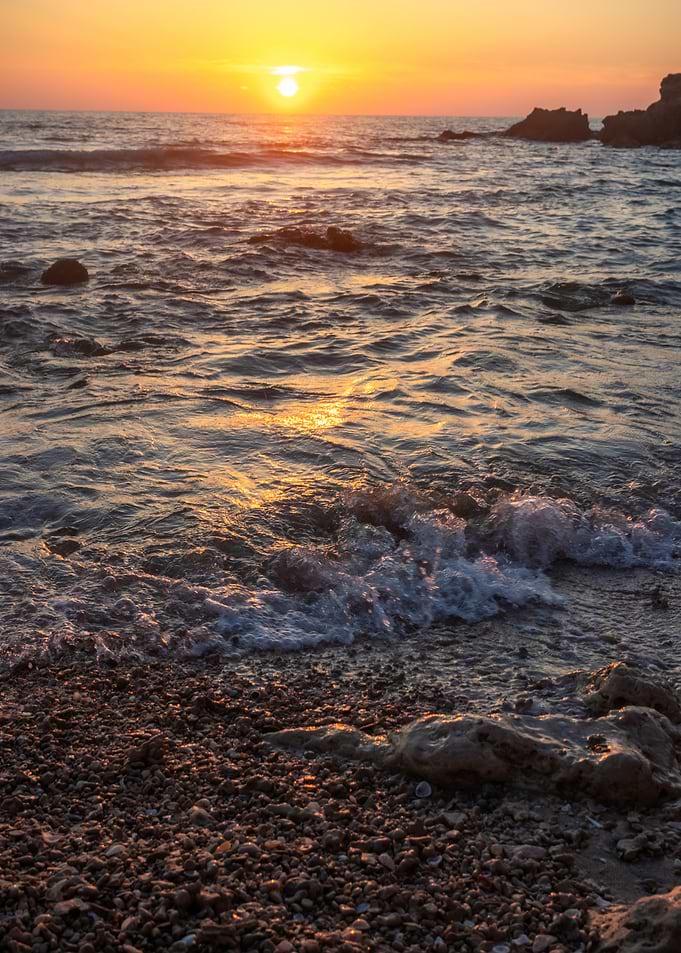 Sunset over the ocean waves
