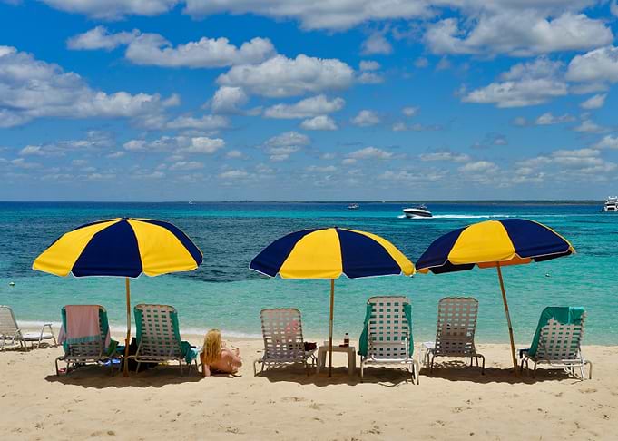 Tropical Beach Scene with Umbrellas and Lounge Chairs