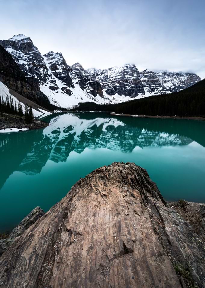 Turquoise Lake Reflecting Snow-Capped Mountains